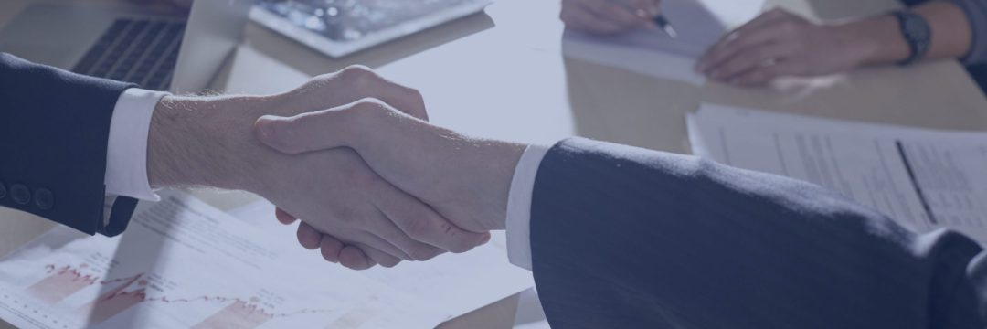 テーブル上で握手するビジネスマン